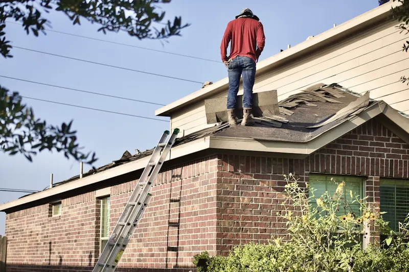 Professional roofer working on a residential roof in Sandy Springs ITP